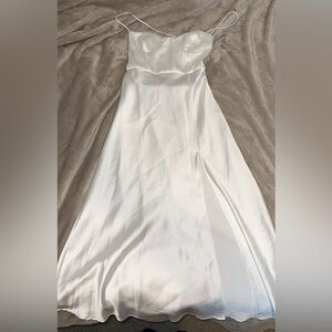NEW WITH TAGS! white flowy dress with a leg slit and criss cross backing